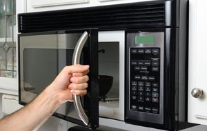opening the door of a microwave